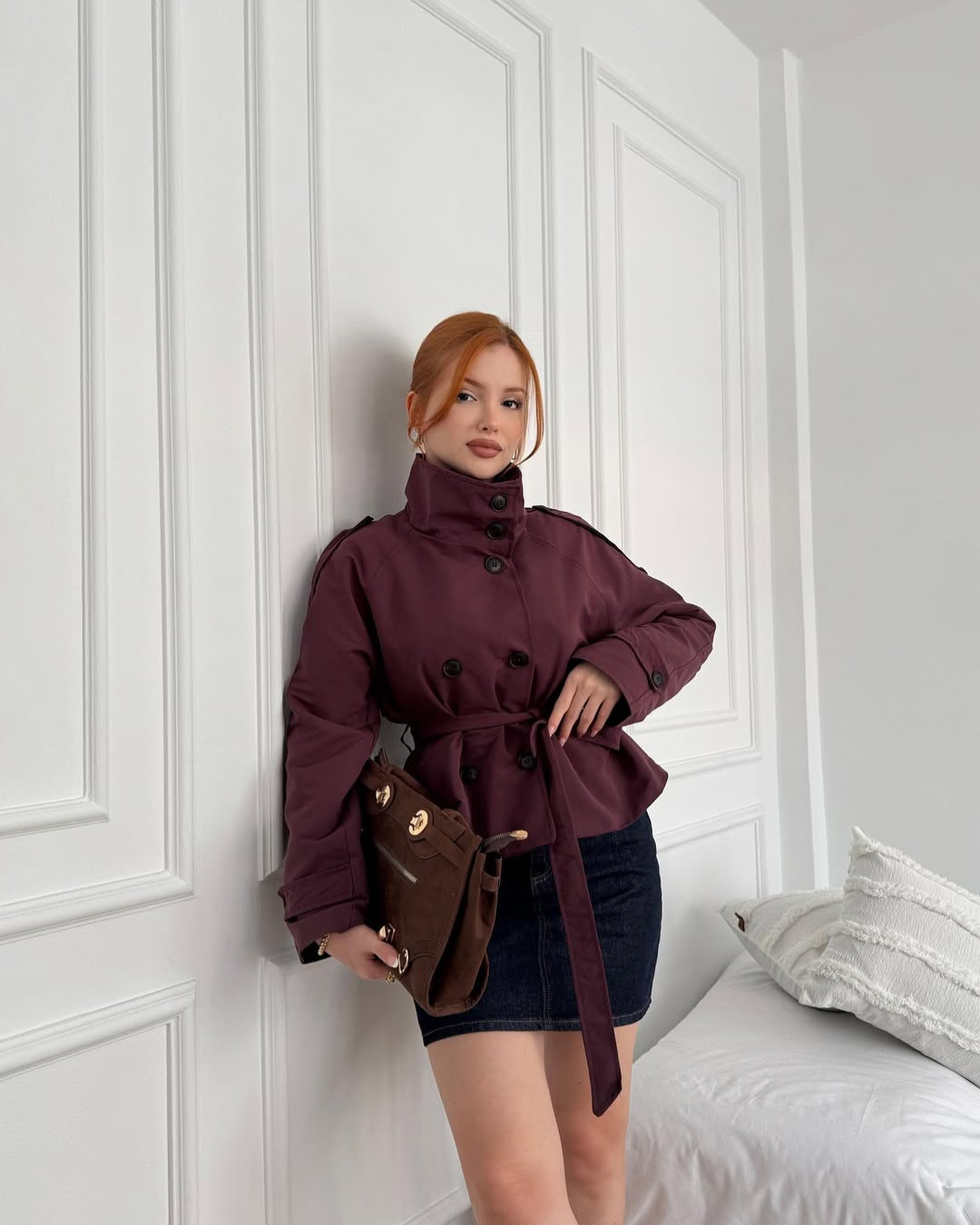 Fashion-forward women's cropped trench coat, double-breasted with a belt. Essential elegant fall outerwear.