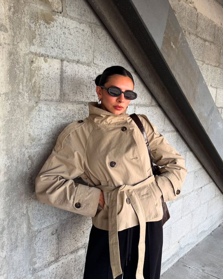 Chic women's cropped trench coat, double-breasted design with a stylish belt for modern outerwear.