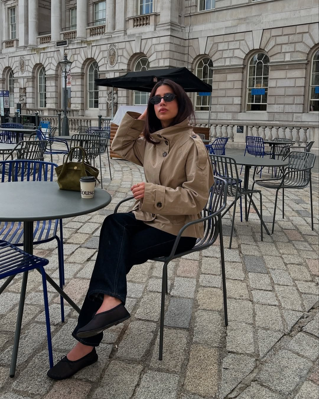 Women's short double-breasted trench coat with belt. Modern fall fashion outerwear.