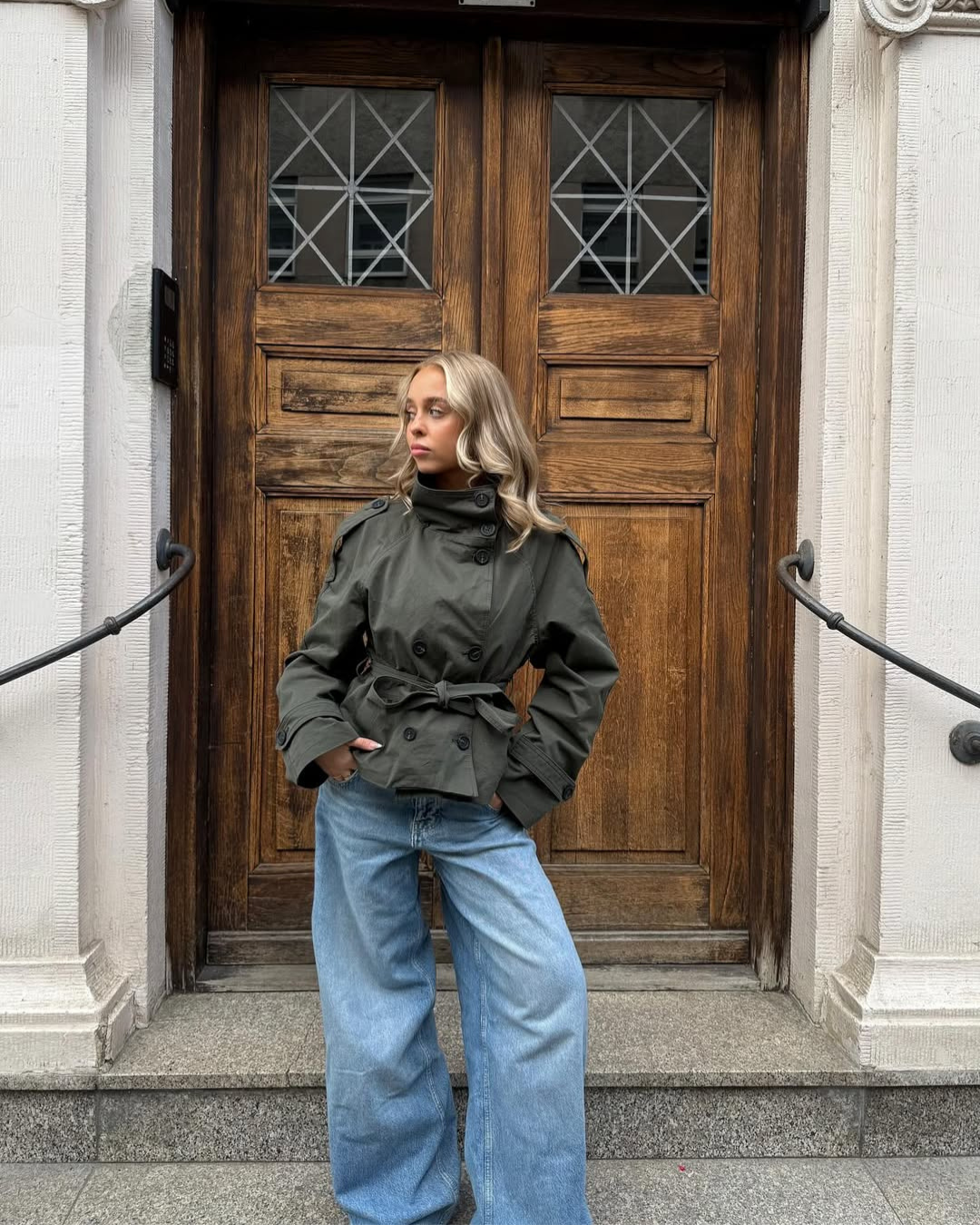 Women's chic cropped trench coat, double-breasted, belted. Essential fall outerwear jacket.