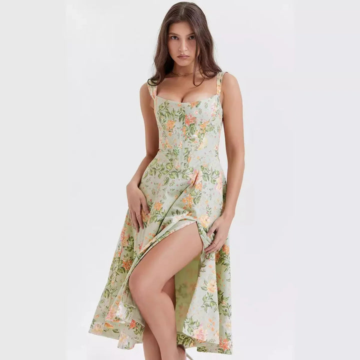 Woman wearing an elegant Dahlia floral midi dress at a summer garden party. Chic special occasion outfit.