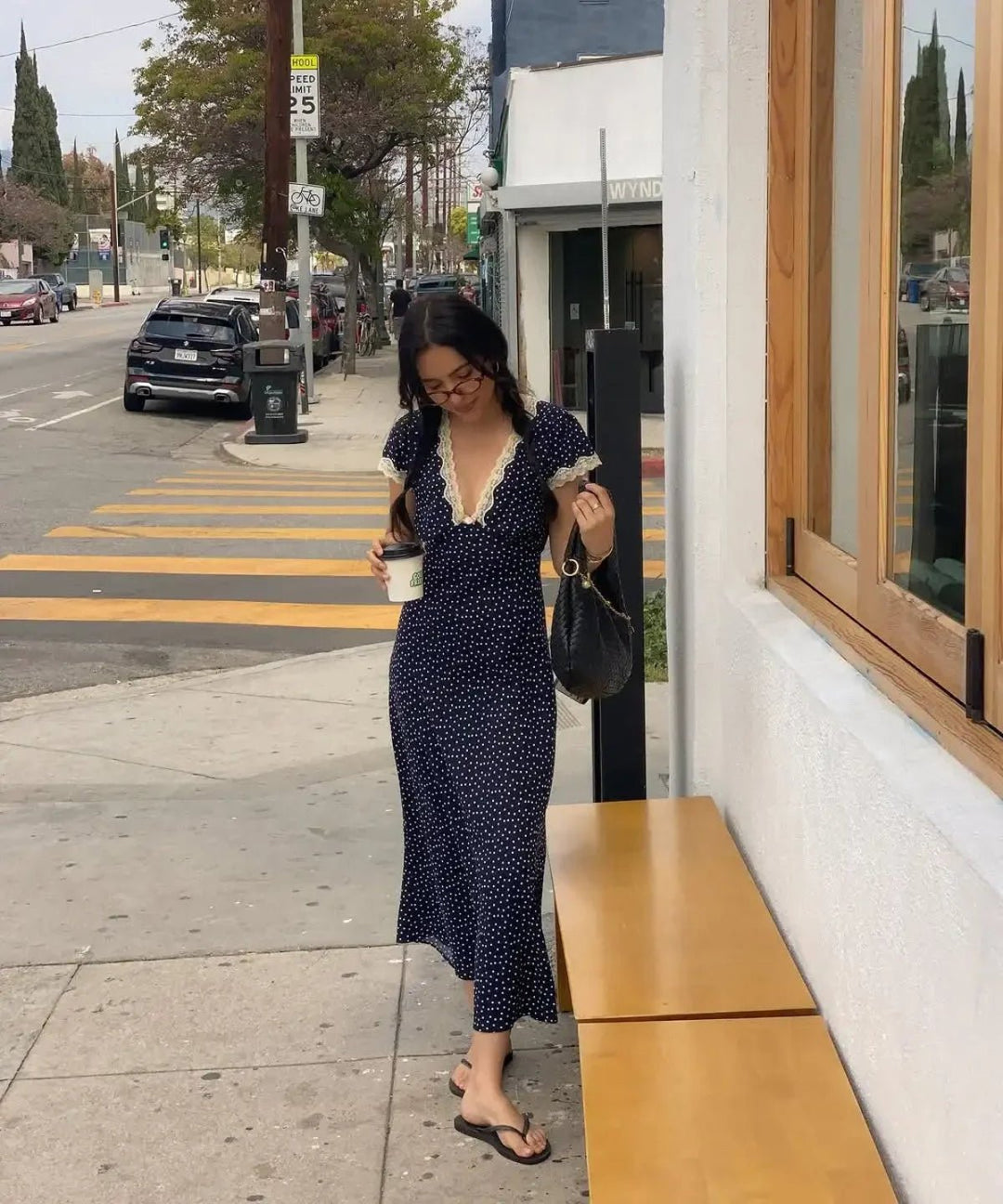 Women's dark blue polka dot midi dress with flutter sleeves, perfect for casual summer elegance & everyday wear.