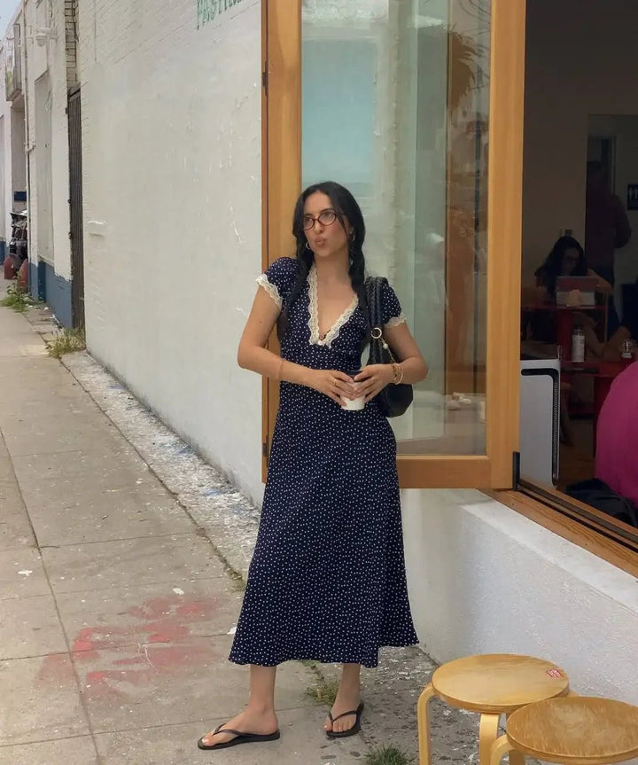 Comfortable women's dark blue polka dot midi dress. Elegant flutter sleeve summer dress for everyday style.
