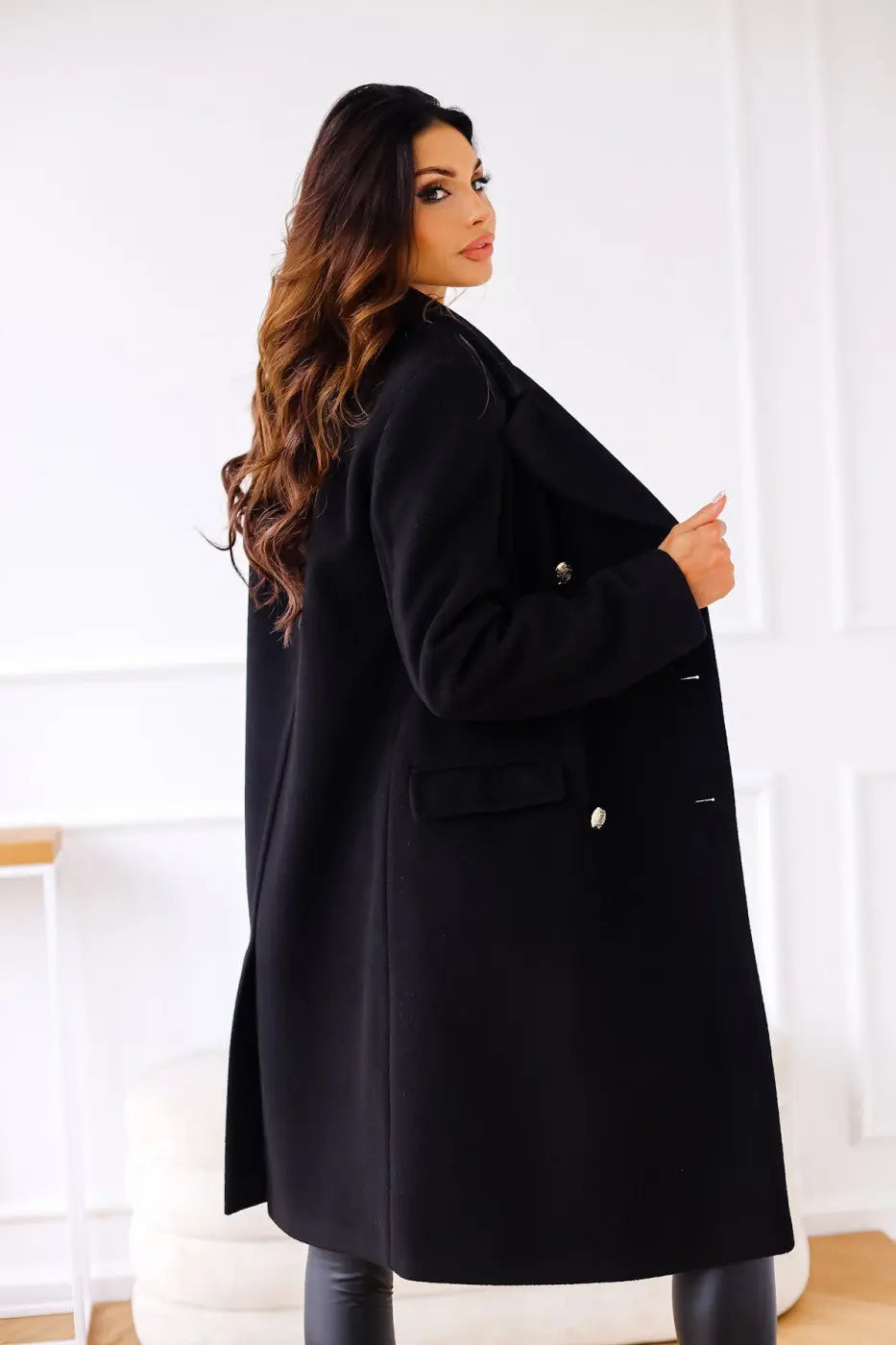 Elegant women's double-breasted long tailored coat, sophisticated winter fashion.
