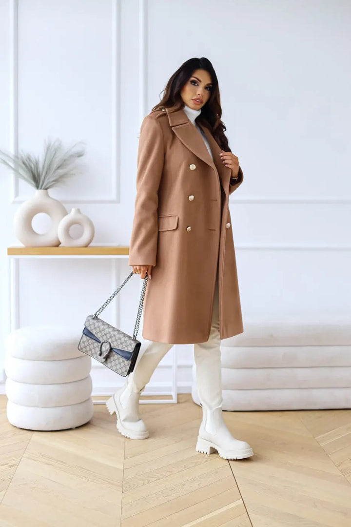Woman in a luxurious double-breasted long tailored coat, classic winter style.