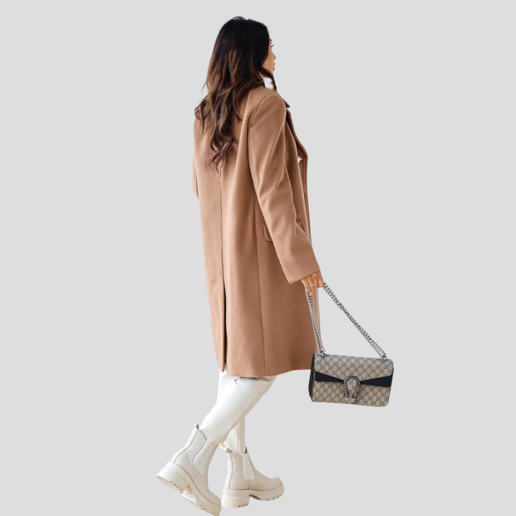 Stylish ladies' longline double-breasted winter coat, perfect elegant outerwear for business or casual chic.
