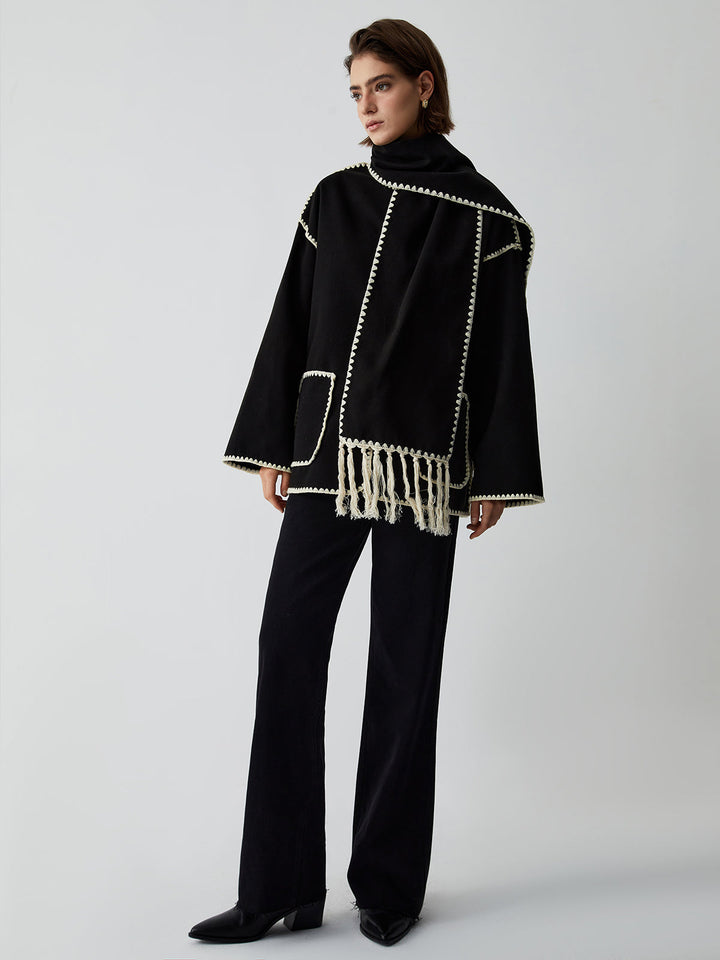 Elegant women's black tailored jacket, featuring a chic fringe scarf for sophisticated winter outerwear.