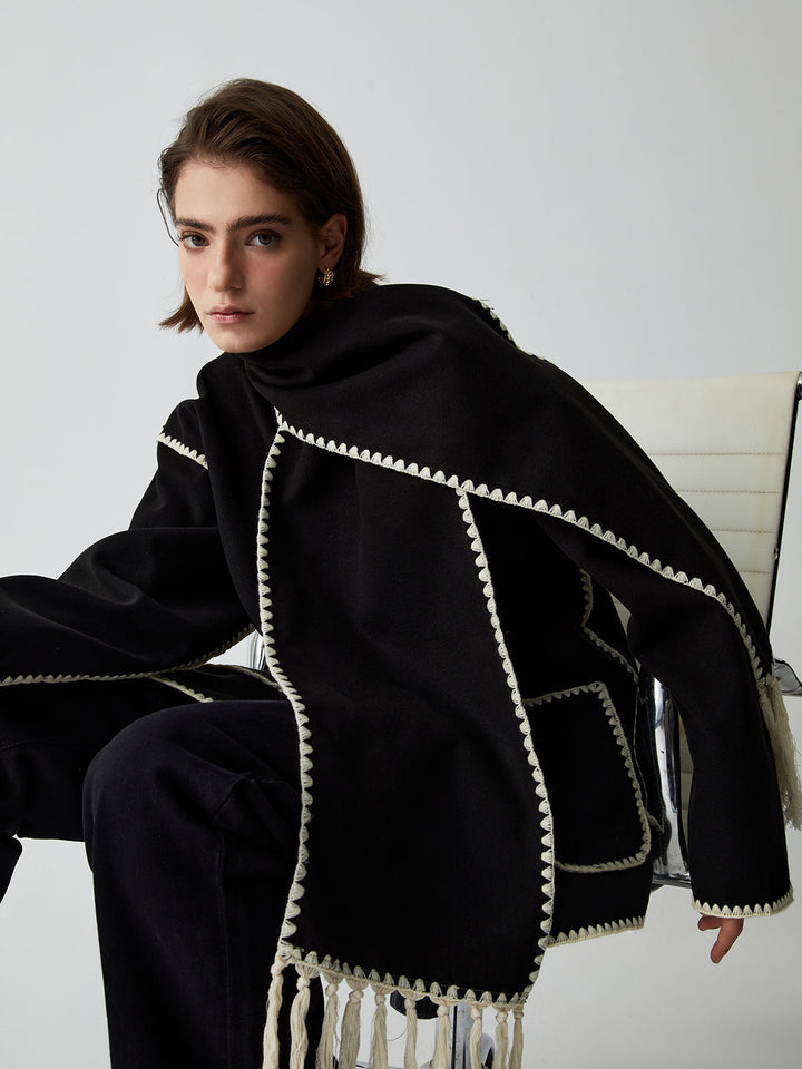 Versatile women's black tailored jacket & fringe scarf combo, essential elegant outerwear for sophisticated winter looks.
