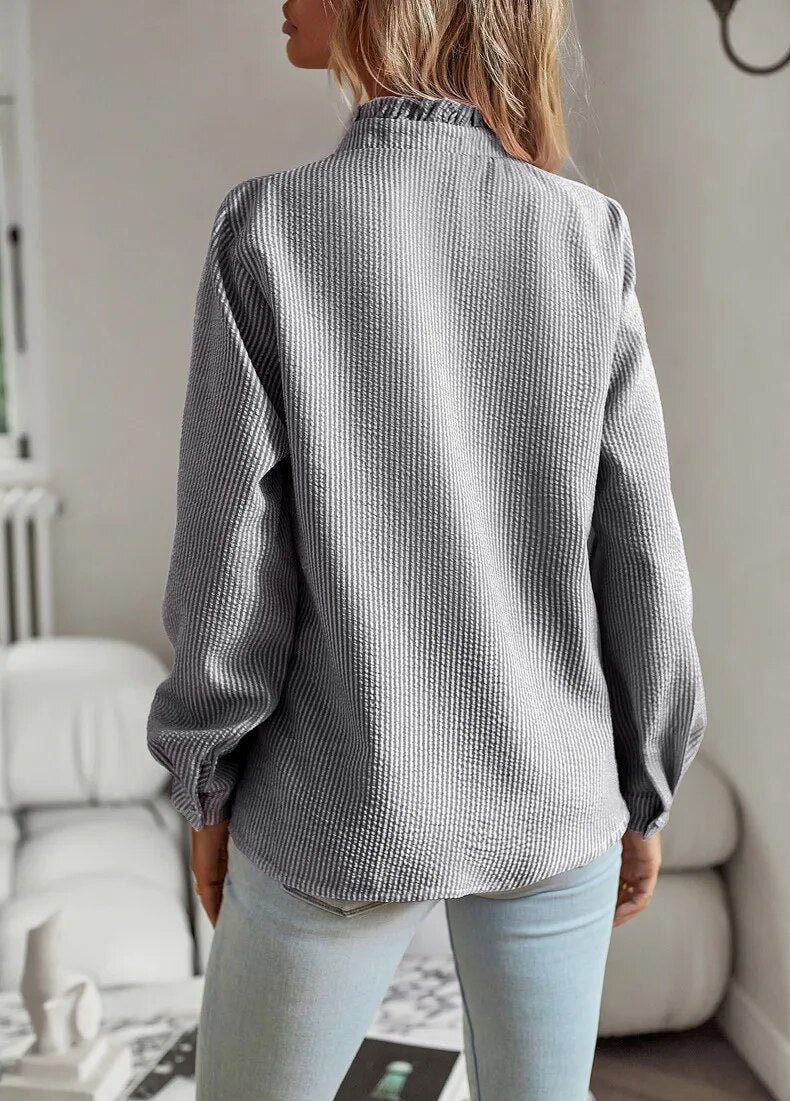 Close-up of women's elegant blouse fabric. Comfortable, timeless style top with sophisticated drape details.