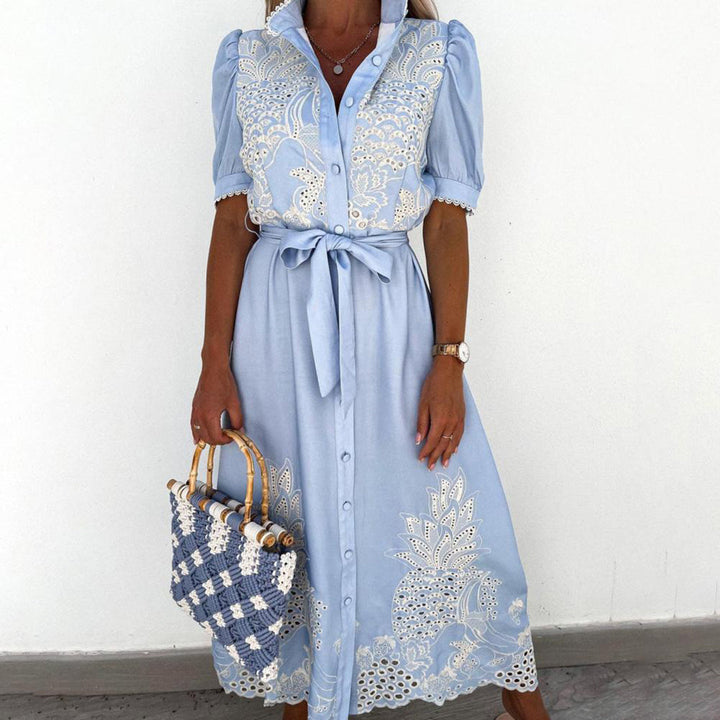 Flowy women's blue maxi dress with delicate embroidery, ideal for casual summer days or beach trips.