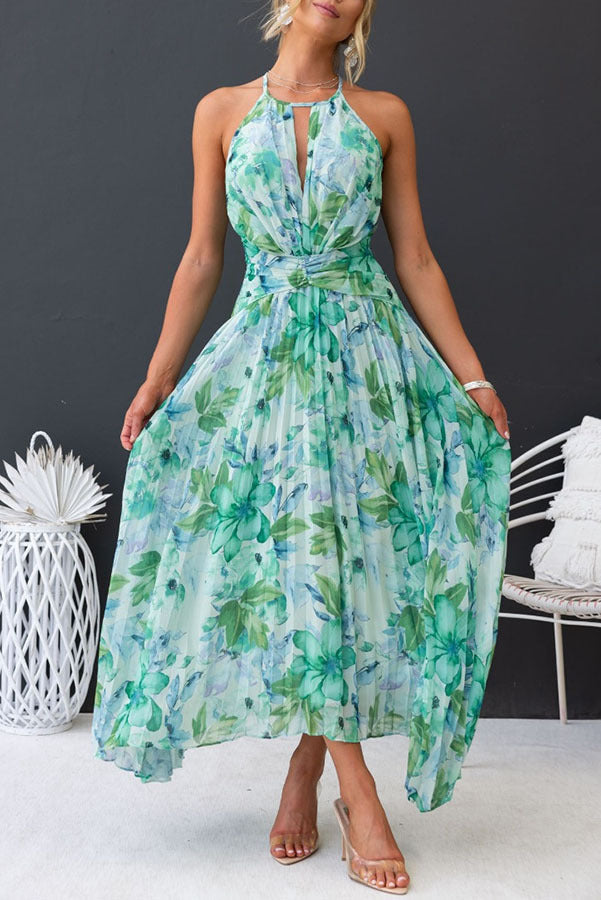 Full shot of a woman wearing a flowing floral halter midi wedding guest dress, suitable for summer occasions.