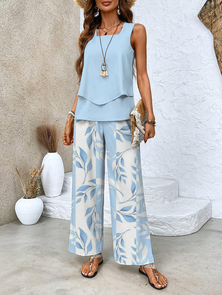 Comfortable women's floral two-piece summer outfit featuring wide-leg trousers & a flowy layered top.