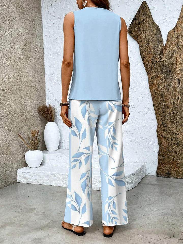 Vibrant floral pattern on this women's two-piece summer set: wide-leg trousers & an elegant layered top.