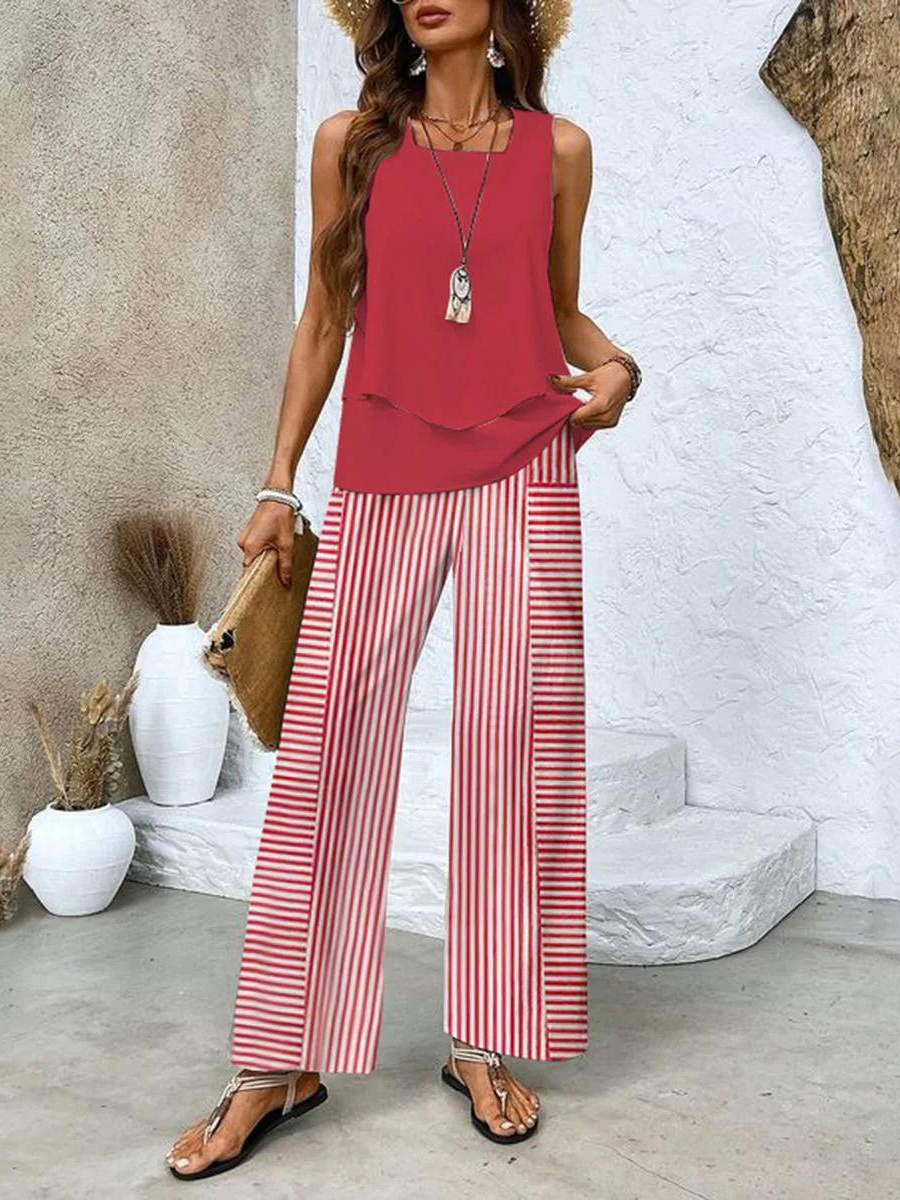 Women's two-piece summer set including wide-leg floral trousers and a matching layered top, resort ready.