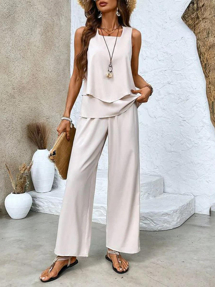 Elegant women's floral two-piece resort wear set with comfortable wide-leg trousers and a chic layered top.