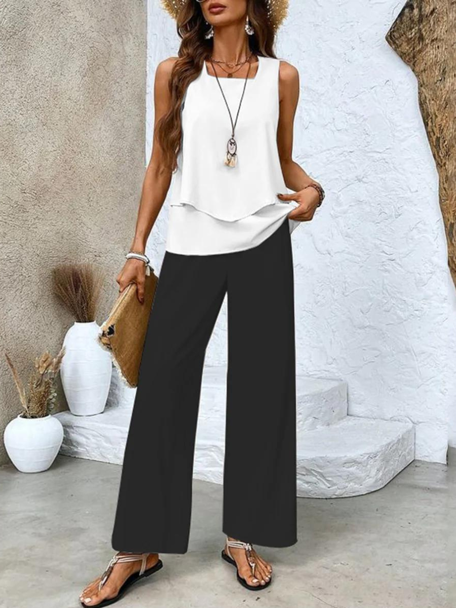 Women's floral two-piece summer set: wide-leg trousers & layered top. Elegant, comfortable resort casual outfit.