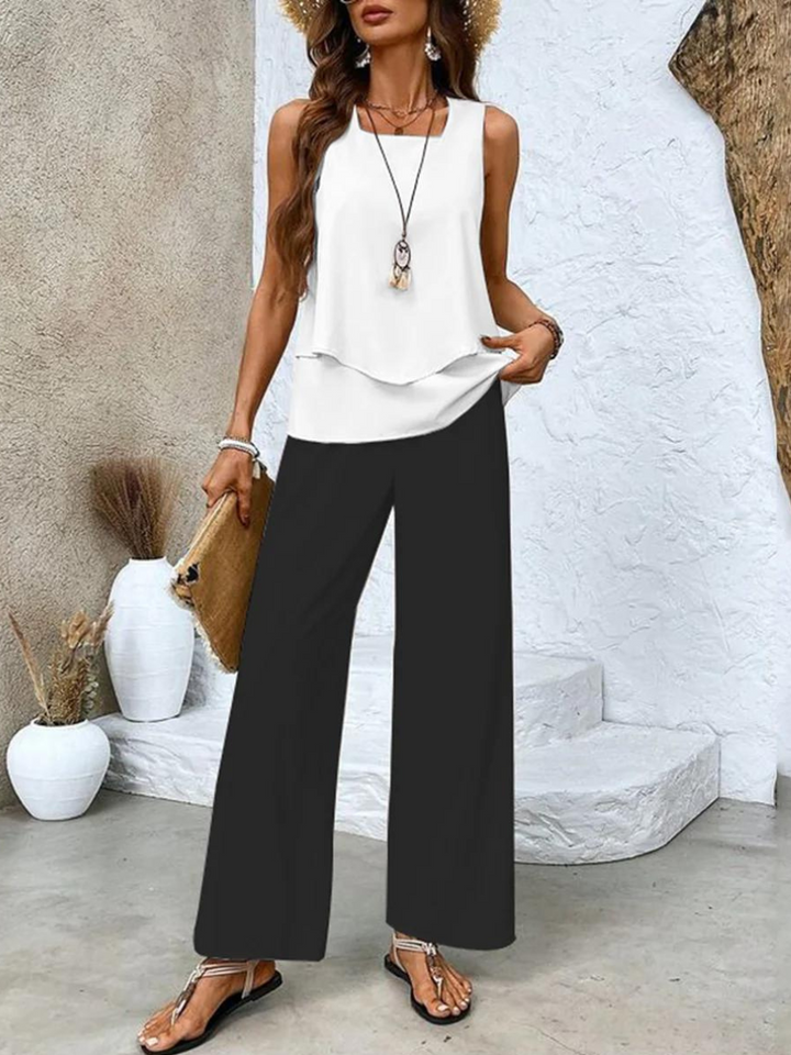 Women's floral two-piece summer set: wide-leg trousers & layered top. Elegant, comfortable resort casual outfit.