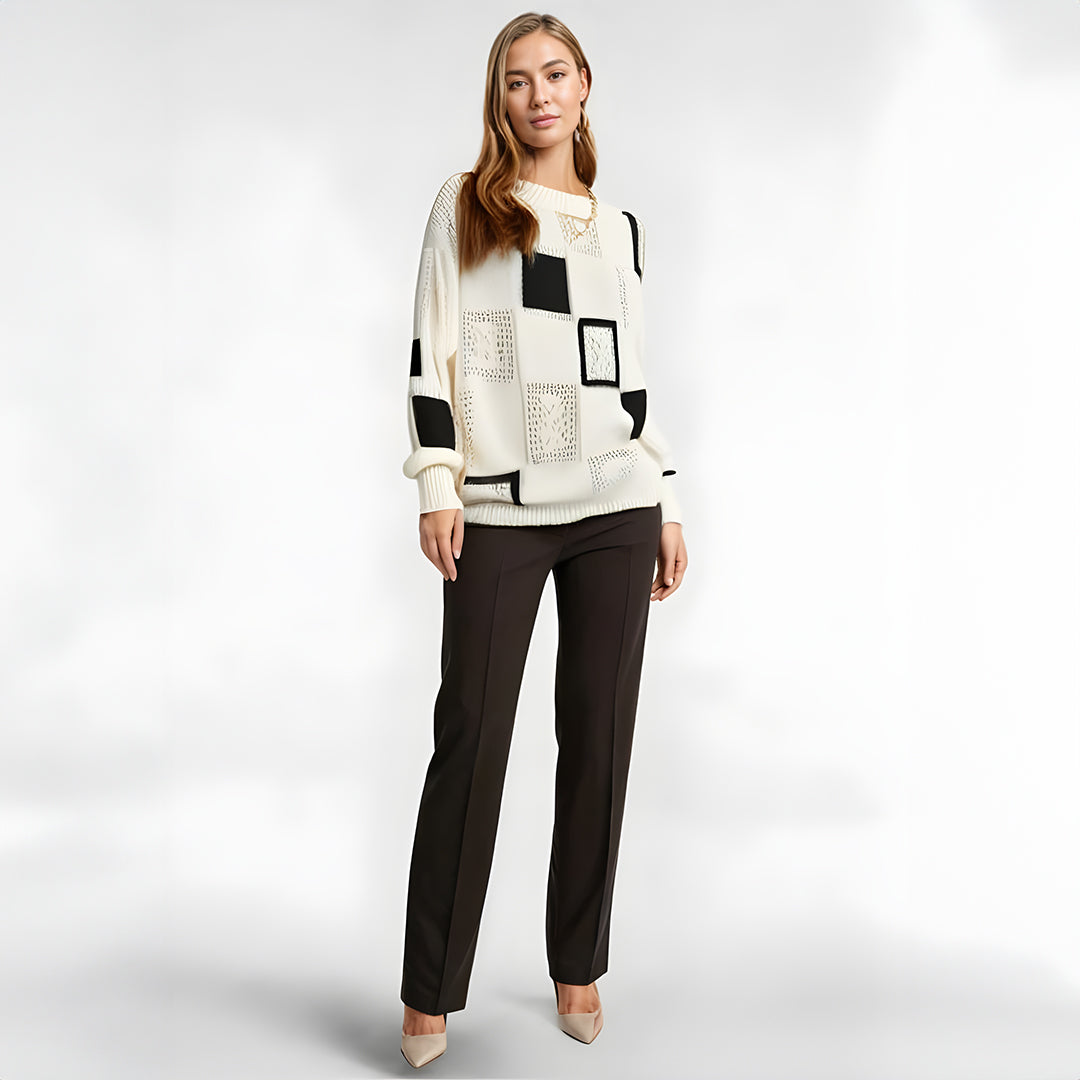 Comfortable women's winter sweater with elegant geometric pattern. Oversized black and white long sleeve top for casual chic.