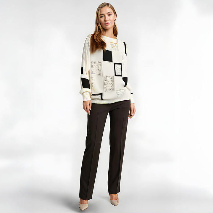 Comfortable women's winter sweater with elegant geometric pattern. Oversized black and white long sleeve top for casual chic.