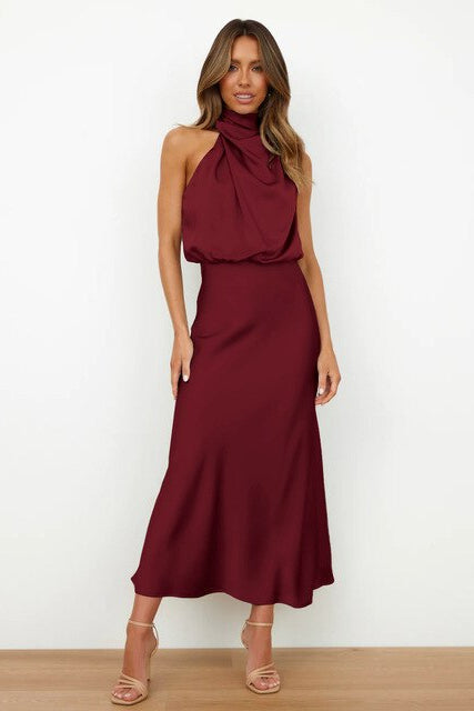 Close-up of the elegant halter neck & bodice detail on a women's formal midi dress, sophisticated style.