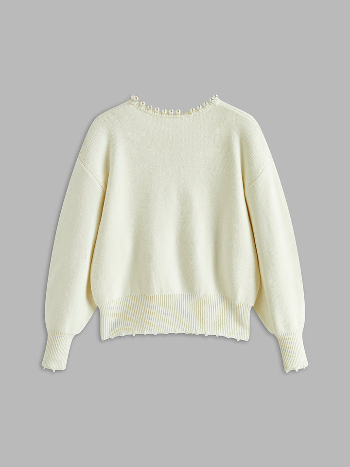 Black women's elegant cardigan featuring delicate pearl trim. A sophisticated round neck layering sweater.