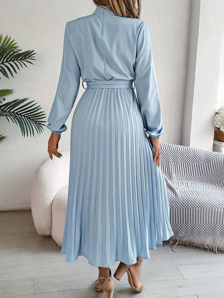 Chic women's belted pleated midi dress, flowy silhouette, great for party or occasion.