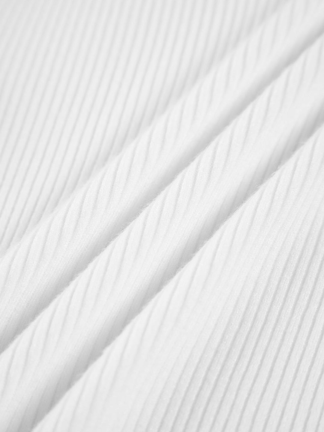 Woman wearing a stylish ribbed high neck top, showcasing its versatile design for everyday wear & layering.