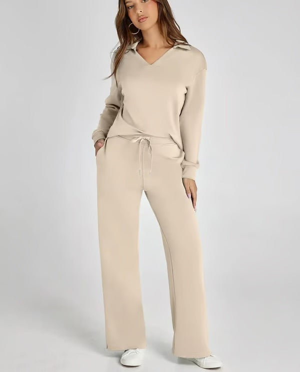 Stylish woman wearing a two-piece lounge set with drawstring pants & collared top for casual outings.