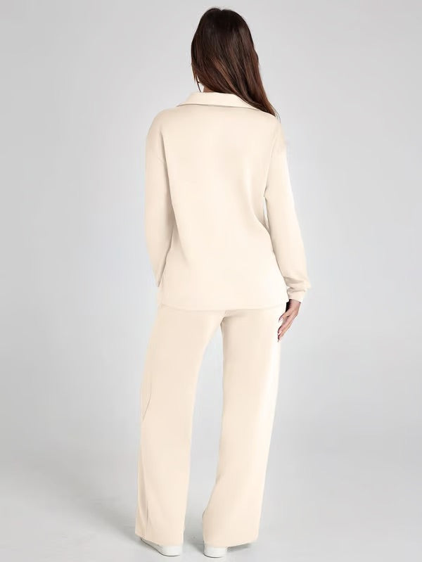Woman in a stylish two-piece lounge set with drawstring pants, showing casual chic pockets.