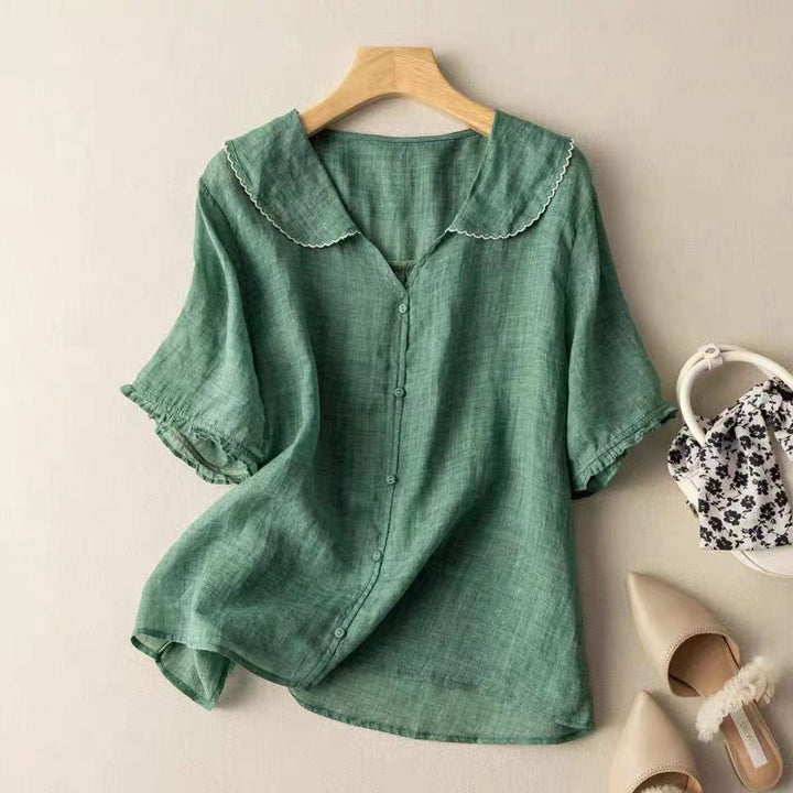 Women's elegant vintage blouse with delicate button detailing, perfect for a classic chic fashion look.