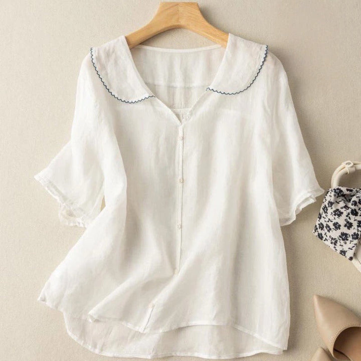 Women's fashion vintage blouse with decorative buttons, a versatile top for a sophisticated or casual ensemble.