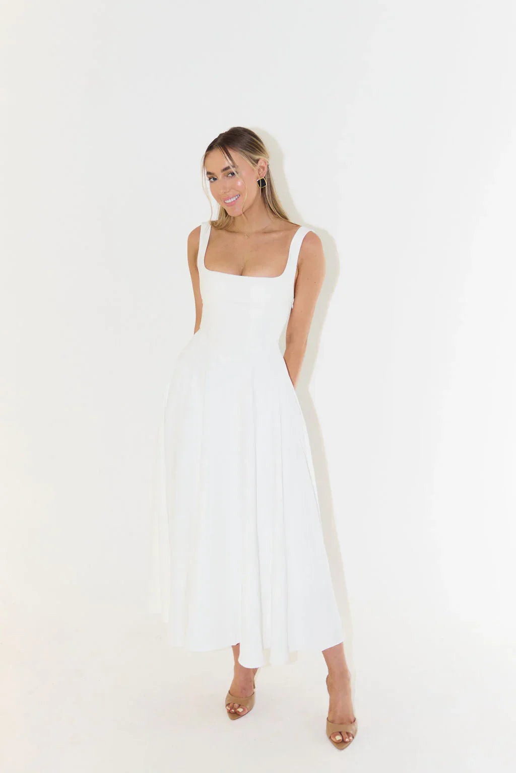 Charming sleeveless white midi dress for women, featuring a square neckline, great for summer events.
