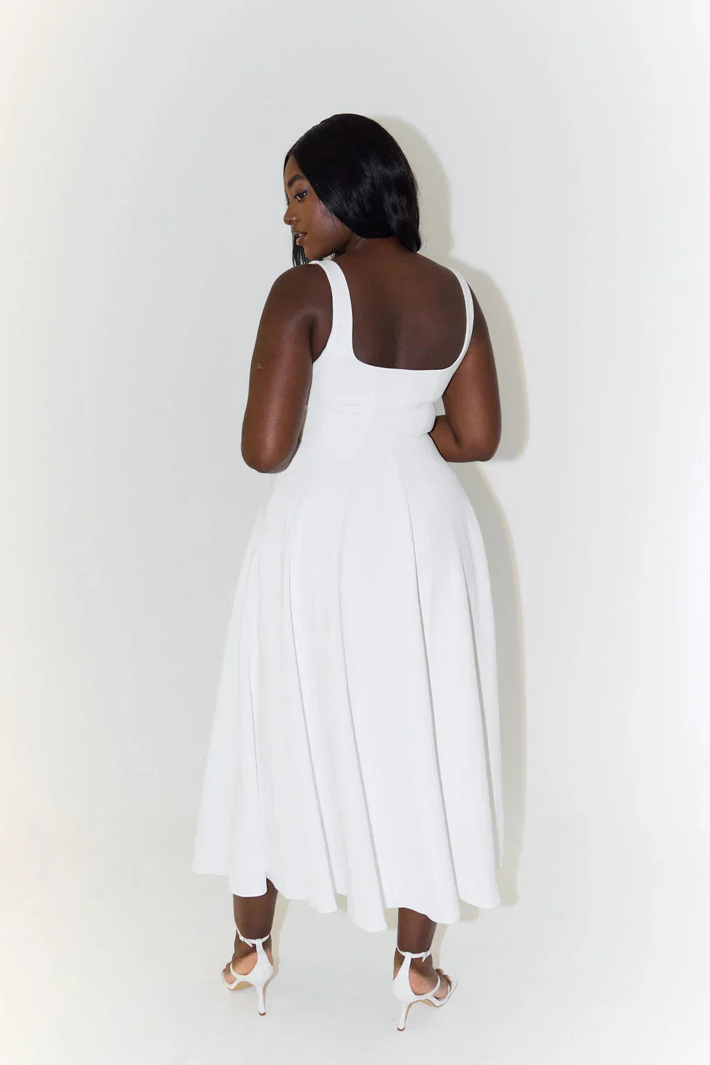 White women's flared midi party dress, a timeless and elegant choice for any special occasion or summer event.