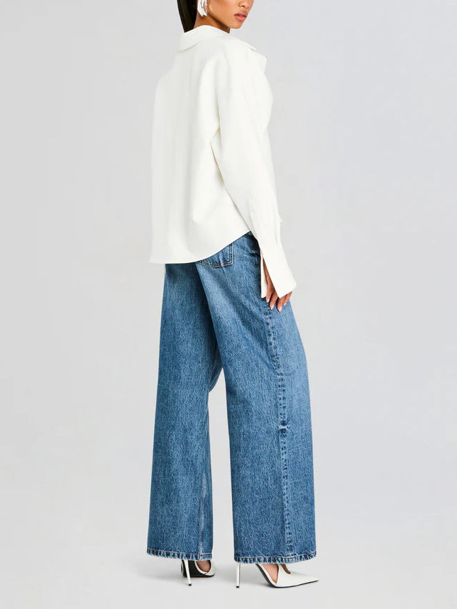Minimalist women's white draped button-down shirt. Elegant blouse offers versatile style for work & casual chic.