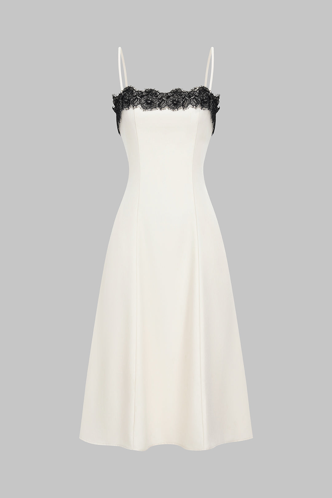 Women's elegant white midi dress with striking black lace accent, perfect for evening or cocktail parties.