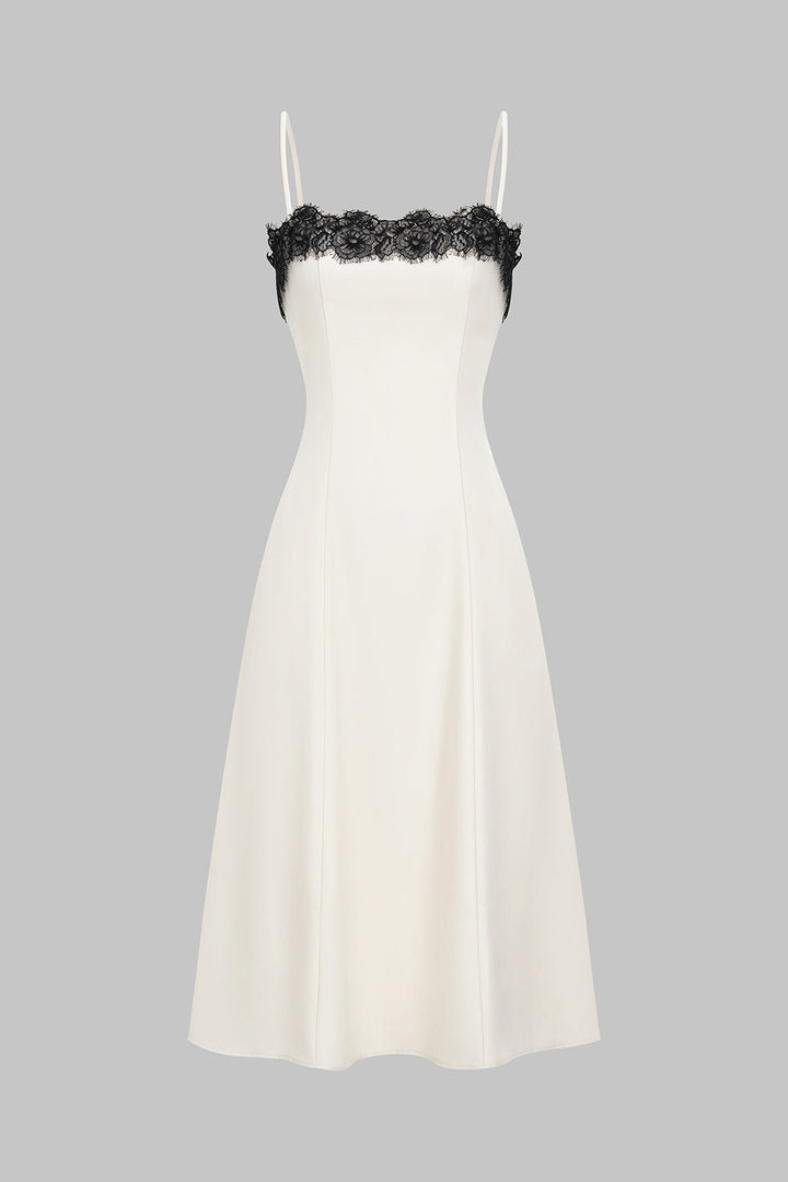 Women's elegant white midi dress with striking black lace accent, perfect for evening or cocktail parties.