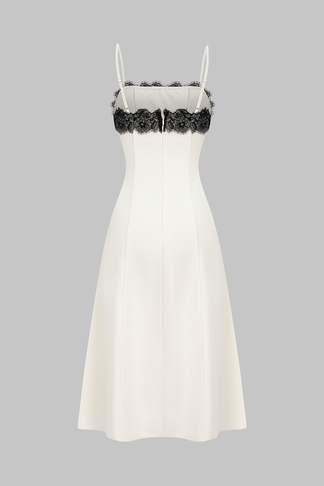 Sleeveless white midi dress for women, featuring a chic black lace design, ideal for formal wear & special occasions.
