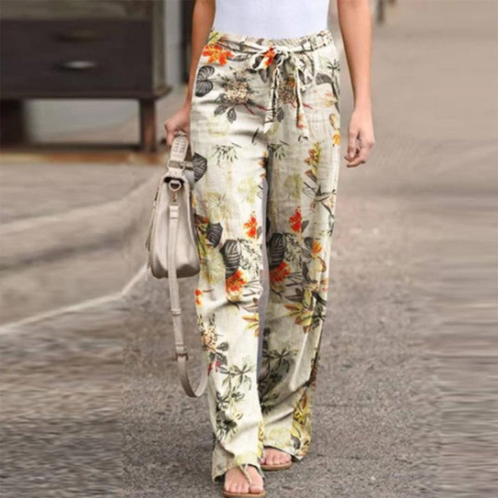 Women's elegant wide-leg pants with vibrant floral print and stylish bow detail, perfect for summer fashion.