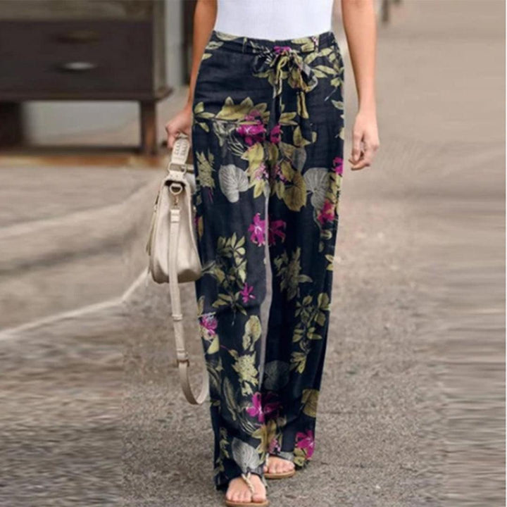 Stylish women's printed pants featuring a beautiful floral pattern and a delicate bow detail for an elegant look.
