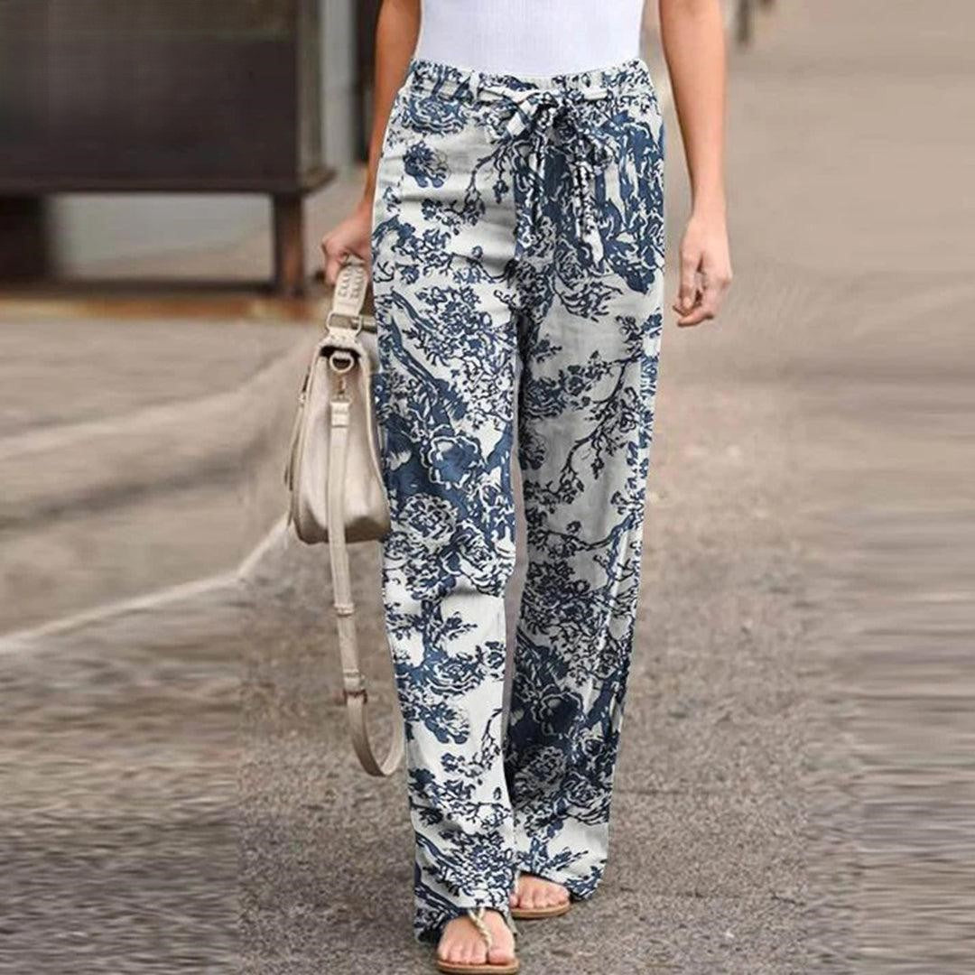 Elegant women's summer pants with a fresh floral print and fashionable bow accent, ideal for casual occasions.