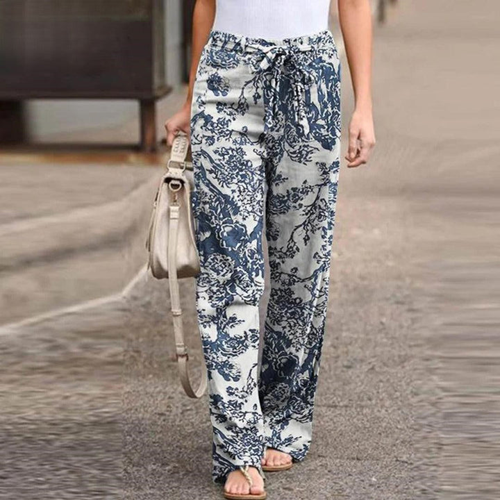 Elegant women's summer pants with a fresh floral print and fashionable bow accent, ideal for casual occasions.