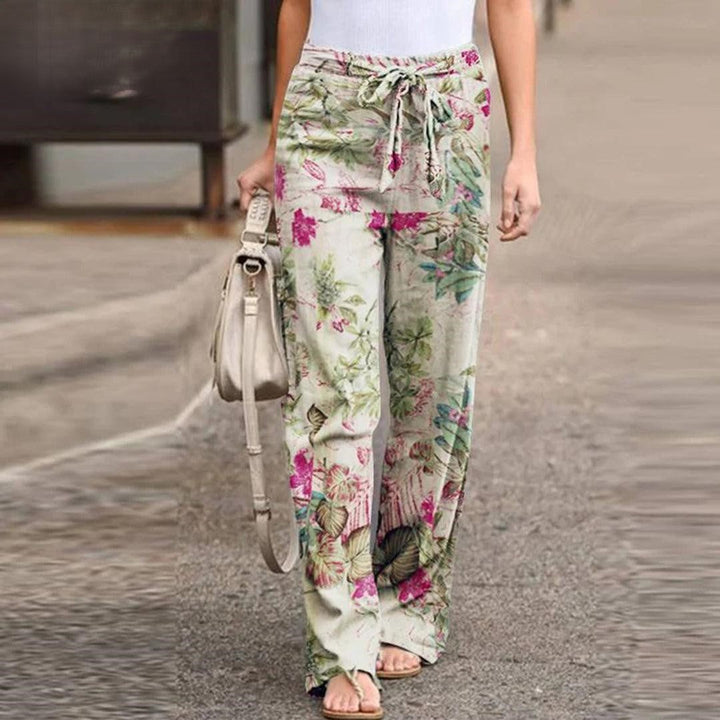 Chic women's wide-leg floral print pants with a playful bow detail, offering comfort and style for any event.
