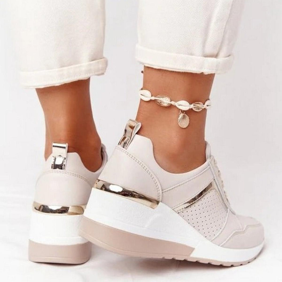 Modern women's platform wedge sneakers with perforated design for casual style & foot support.