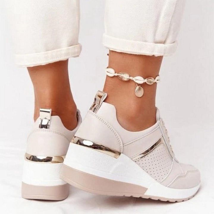 Modern women's platform wedge sneakers with perforated design for casual style & foot support.