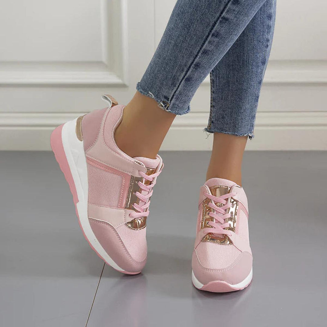 Women's perforated platform wedge sneakers, modern design for all-day casual comfort.