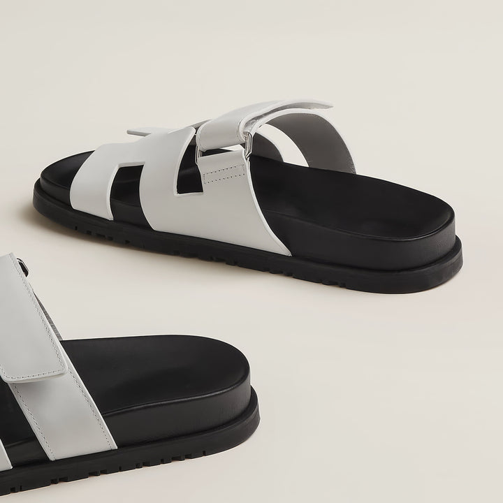 Chic women's flat slip-on sandals. Features cut-out design for effortless summer fashion.