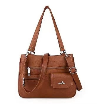 Interior view of a women's multi-compartment handbag, showing organized storage.