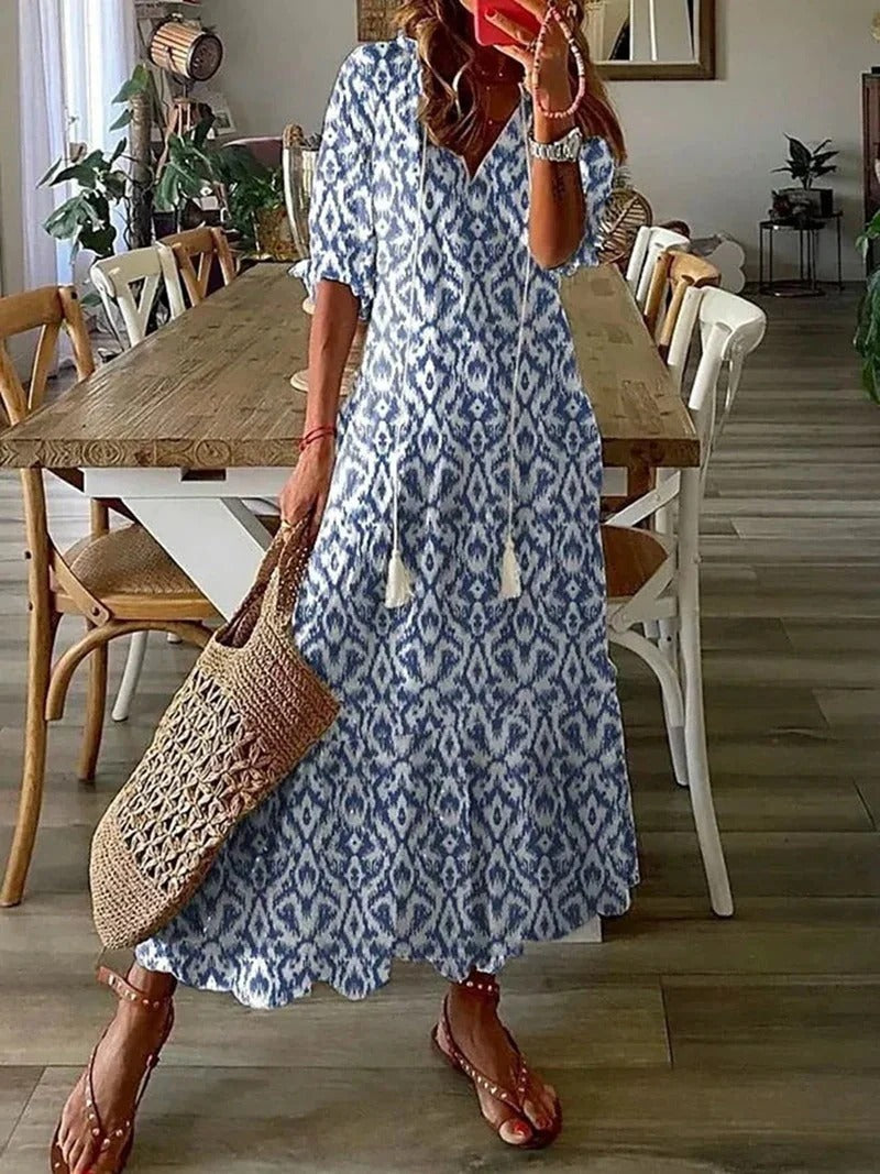 Women's flowy long boho dress, A-line maxi style with elegant leaf & stripe print. Ideal for summer.