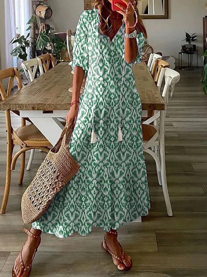 Chic women's flowy long summer dress, bohemian leaf & stripe print, perfect for casual elegance.
