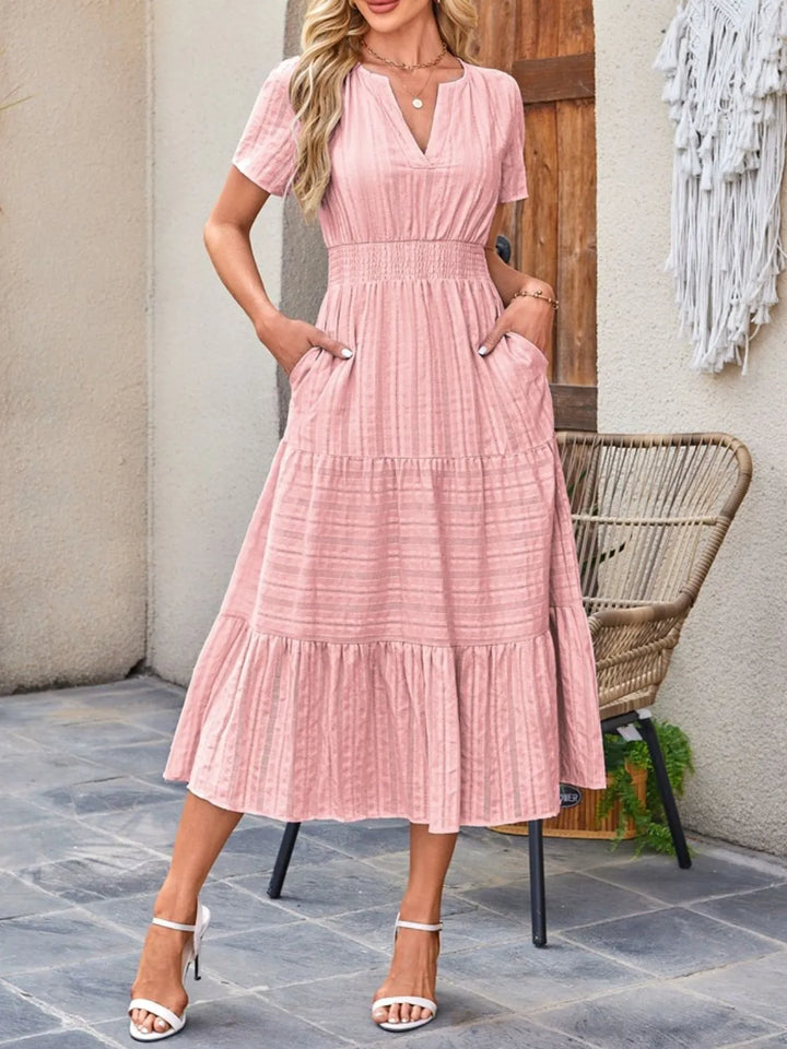 Women's flowy midi dress with practical pockets, ideal for casual summer wear.